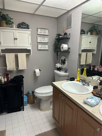 a bathroom with a sink vanity and a toilet