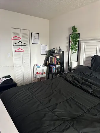 a bedroom with a bed next to a window with the outer view