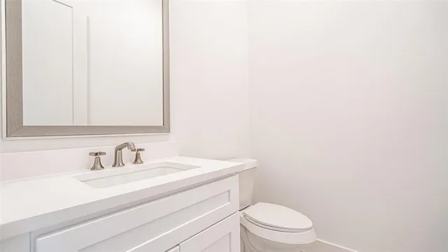 a bathroom with a sink a toilet and mirror