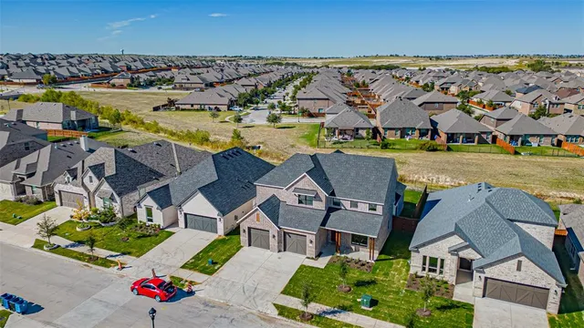 an aerial view of residential houses with outdoor space and swimming pool