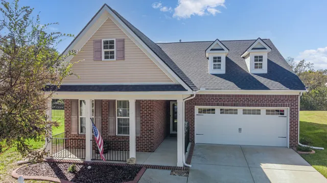 a view of a house with a garage and balcony