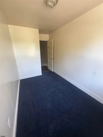 a view of an empty room with closet