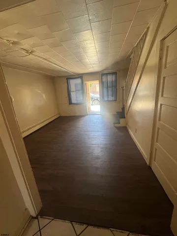 a view of a livingroom with wooden floor and a window