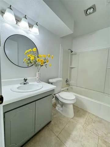 a front view of a house with a yard and potted plants