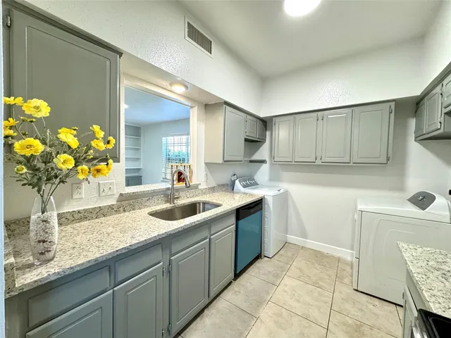 a kitchen with a sink and cabinets