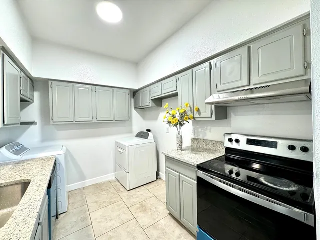 a kitchen with granite countertop cabinets and steel appliances