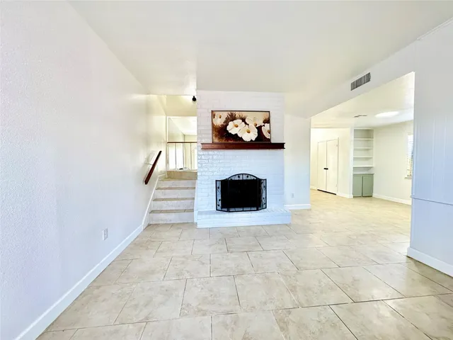 a living room with a fireplace and a painting on the wall