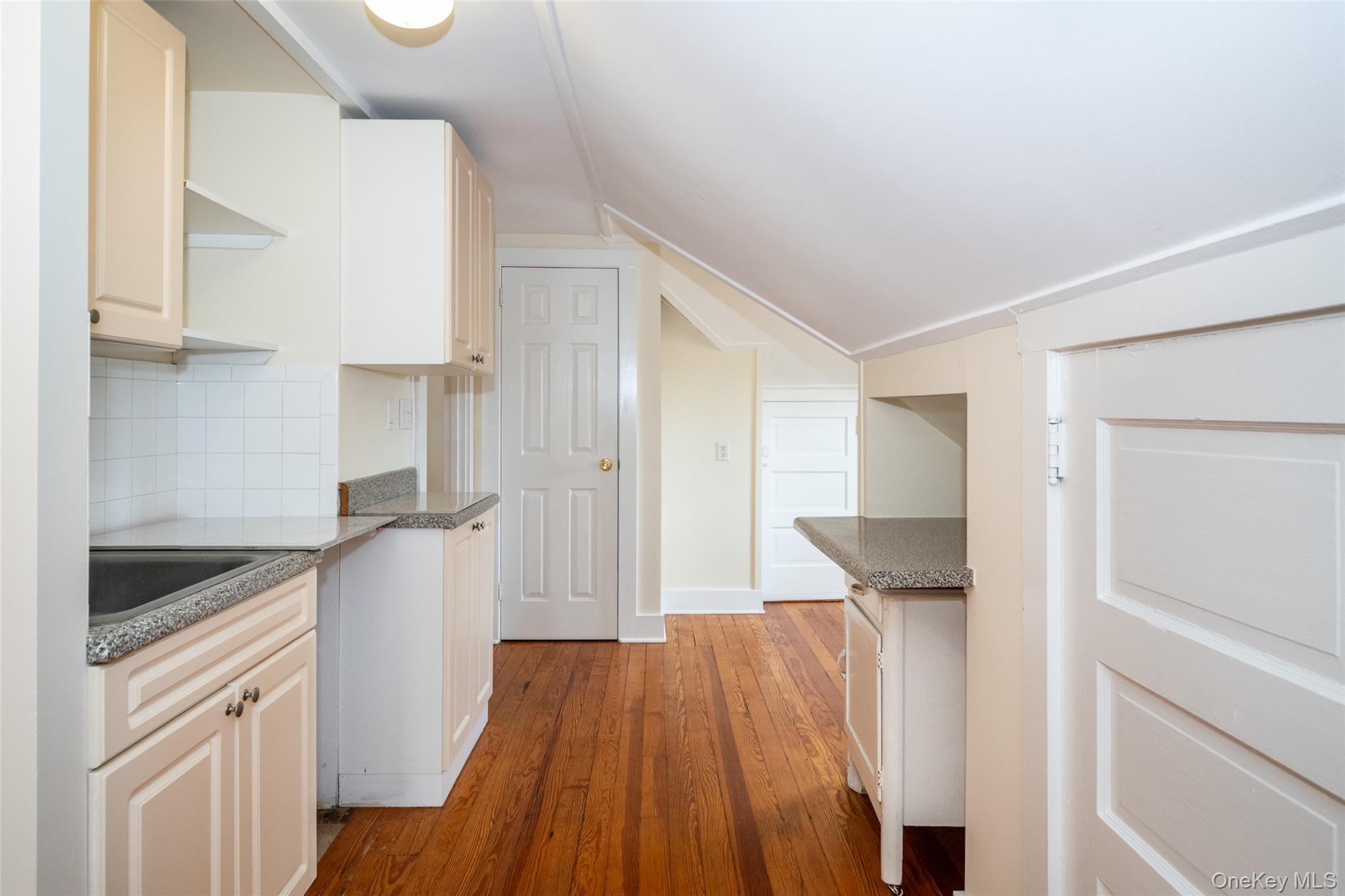 82 Clove Road New Rochelle, NY 10801 - Photo 24 of 39 a kitchen with granite countertop a refrigerator and a sink