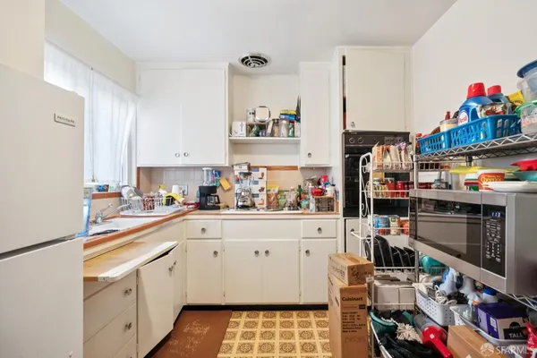 a kitchen with stainless steel appliances a lot of counter top space and cabinets