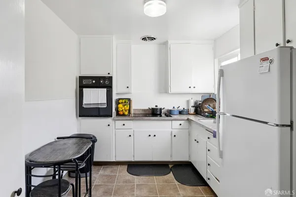 a kitchen with granite countertop a sink stove and refrigerator