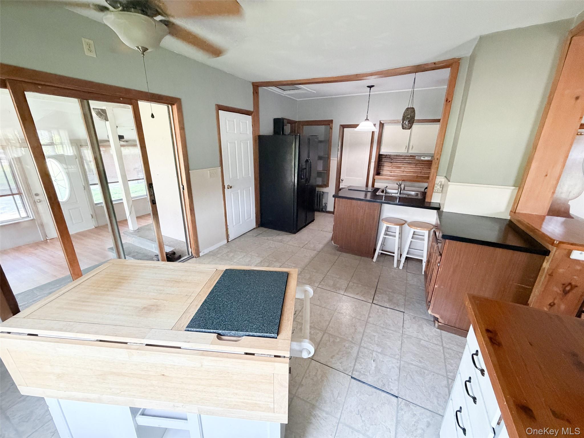 77 Rockland Road Roscoe, NY 12776 - Photo 6 of 20 Kitchen featuring tile flooring, dark countertops, wood-finish cabinetry, and a ceiling fan