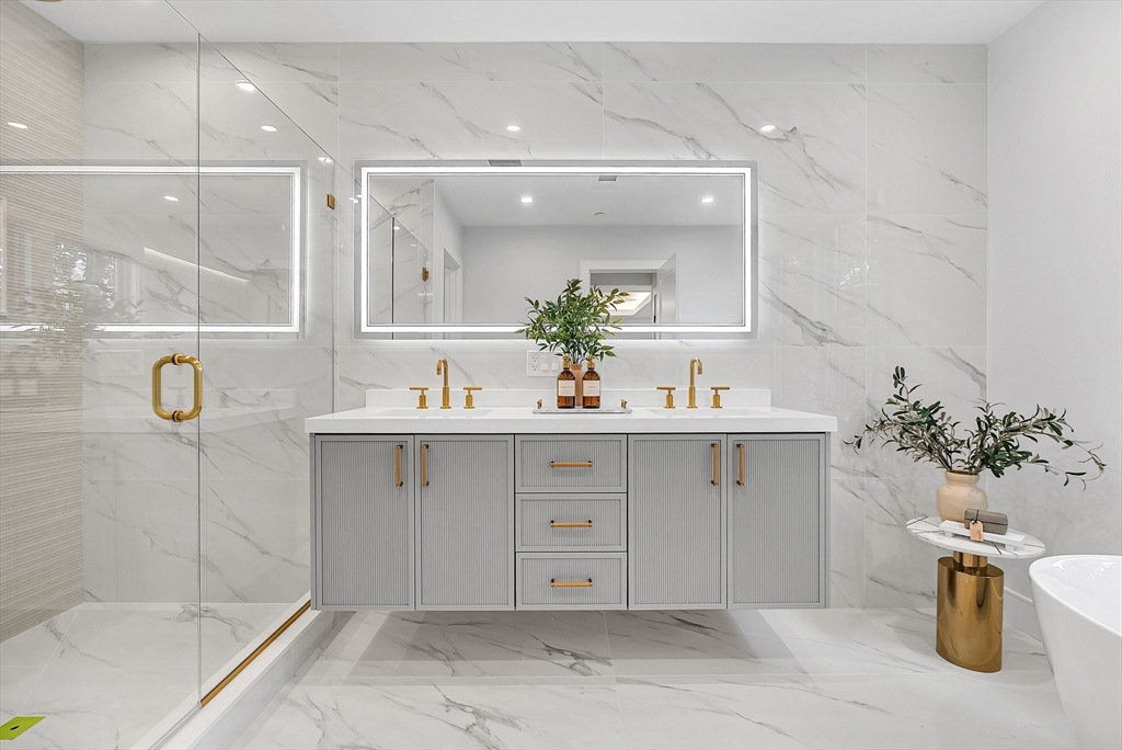 282 Nevada Street, Unit 282 Newton, MA 02460 - Photo 13 of 30 a bathroom with a sink mirror and a shower