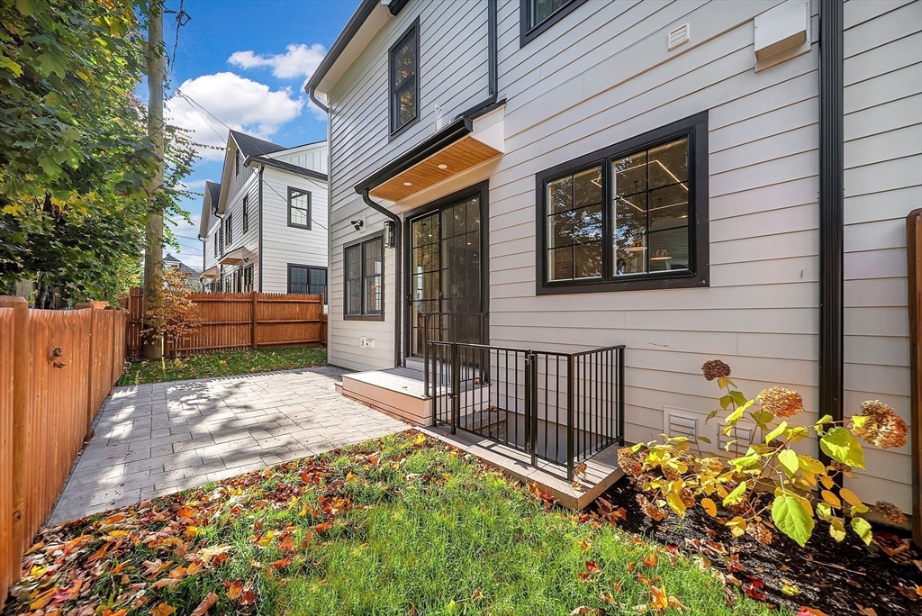 282 Nevada Street, Unit 282 Newton, MA 02460 - Photo 23 of 30 a view of a brick house with a flower garden