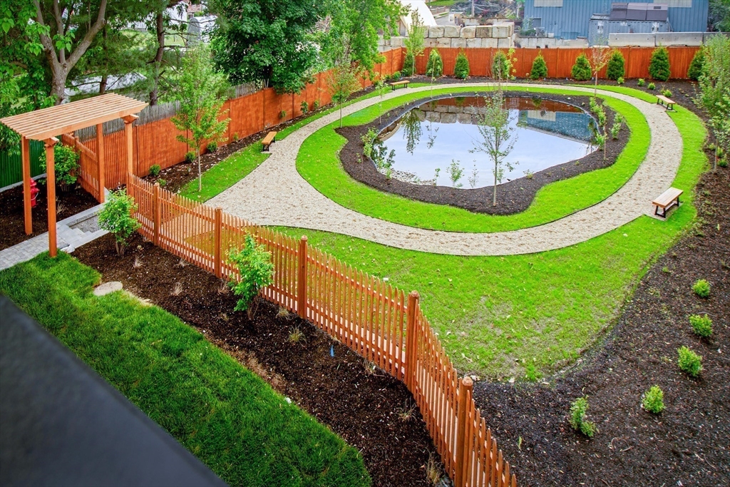 282 Nevada Street, Unit 282 Newton, MA 02460 - Photo 27 of 30 a view of a swimming pool with a yard