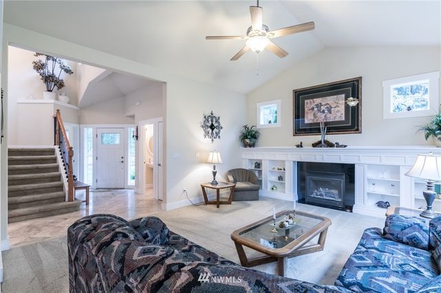 a living room with furniture a fireplace and wall paintings