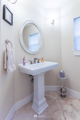 a bathroom with a sink toilet and a mirror