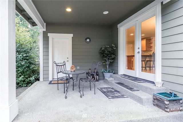 a view of a patio with table and chairs and potted plants