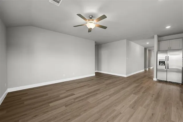 a kitchen with a sink a microwave and cabinets