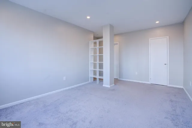 a bathroom with a granite countertop toilet sink and mirror