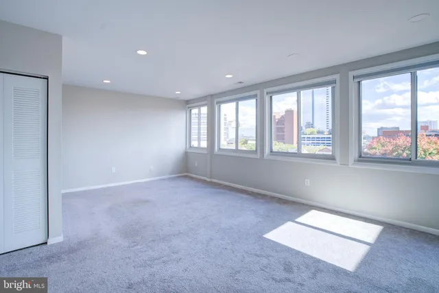 a view of a livingroom with an empty space and a window
