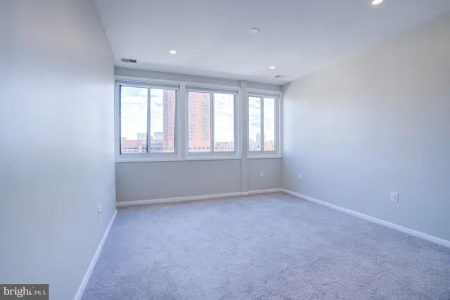 a bathroom with a granite countertop sink a toilet and mirror