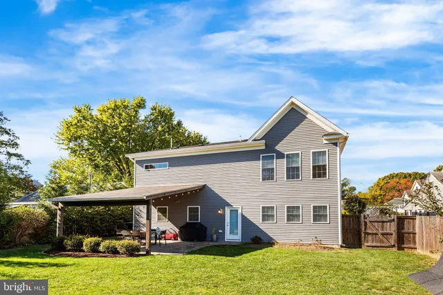a view of a backyard with sitting area furniture and garden