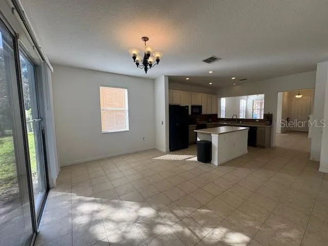 a view of a kitchen with a sink and cabinets