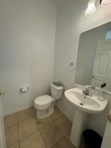 a white toilet sitting next to a bathroom sink