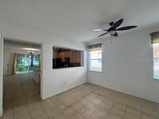 a view of a livingroom with an empty space and a window