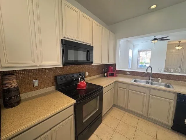 a kitchen with a sink and cabinets
