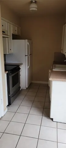 a kitchen with a stove and a refrigerator