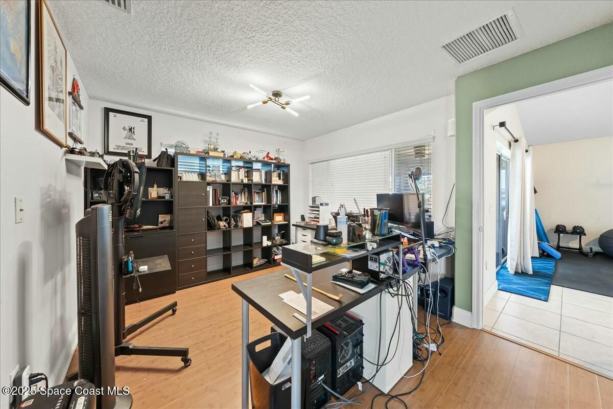 1366 Blazen Ridge Court Melbourne, FL 32934 - Photo 12 of 23 a living room with lots of furniture and gym equipment