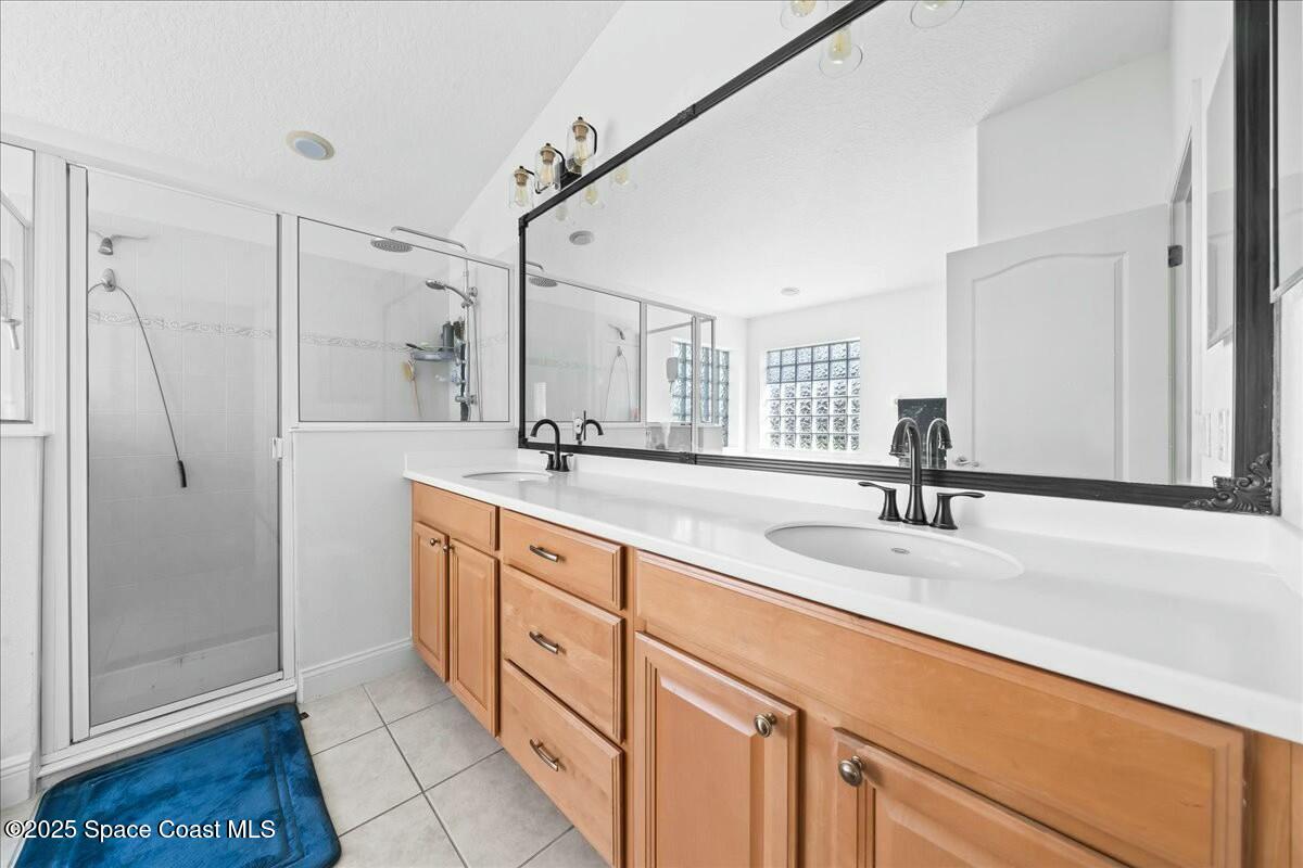 1366 Blazen Ridge Court Melbourne, FL 32934 - Photo 14 of 23 a spacious bathroom with a double sink shower and a mirror