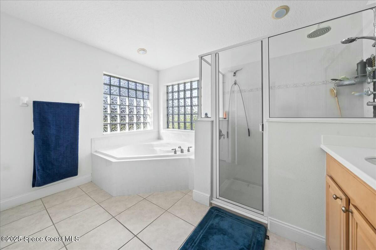 1366 Blazen Ridge Court Melbourne, FL 32934 - Photo 15 of 23 a bathroom with a bathtub and a shower