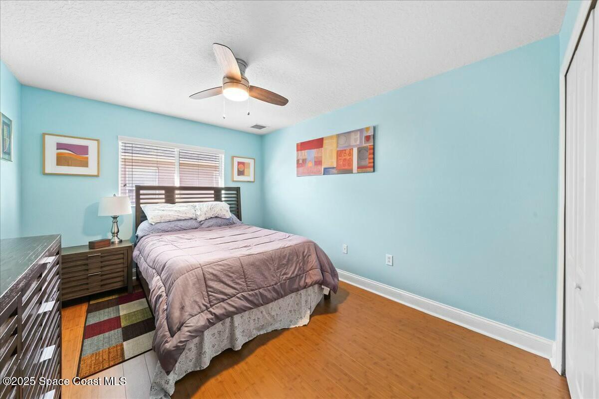 1366 Blazen Ridge Court Melbourne, FL 32934 - Photo 16 of 23 a bedroom with a bed and a painting on the wall