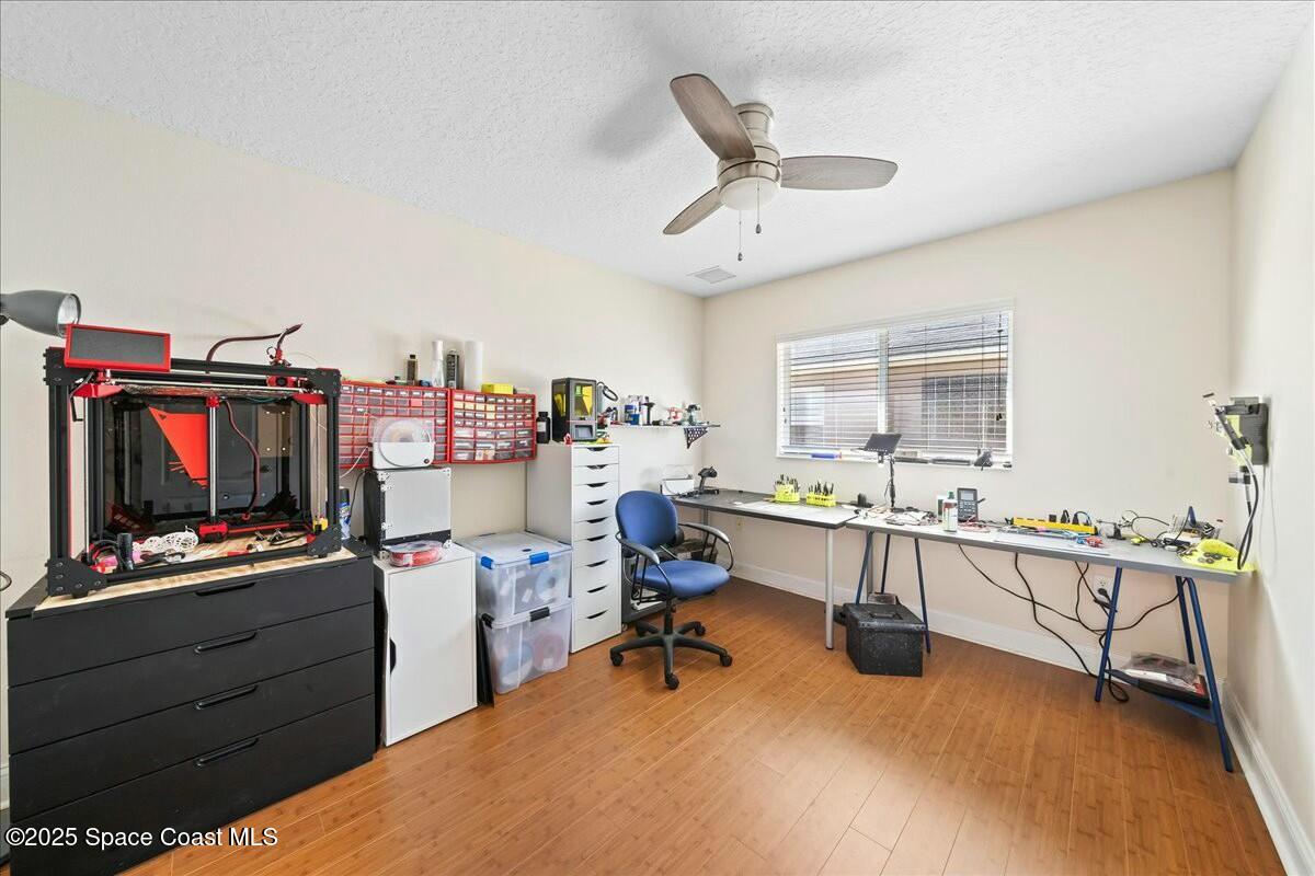 1366 Blazen Ridge Court Melbourne, FL 32934 - Photo 18 of 23 a view of a workspace with furniture and a kitchen