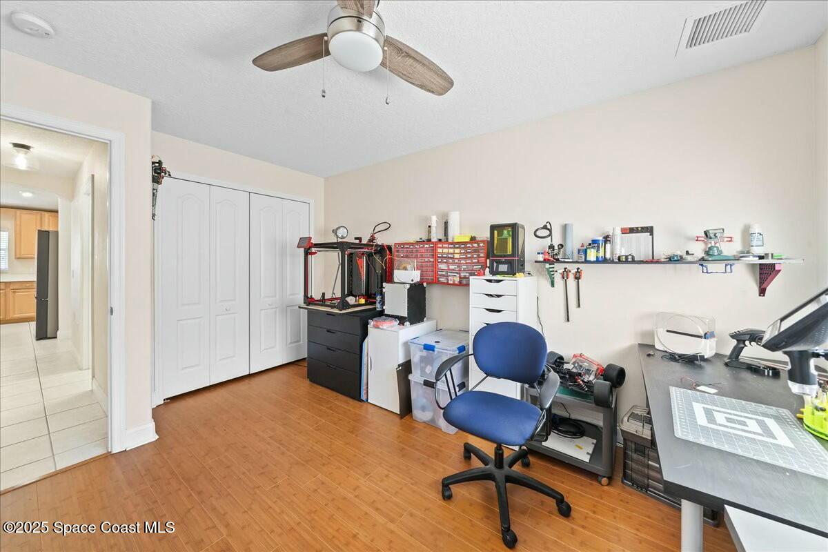 1366 Blazen Ridge Court Melbourne, FL 32934 - Photo 19 of 23 a workspace with furniture and a ceiling fan