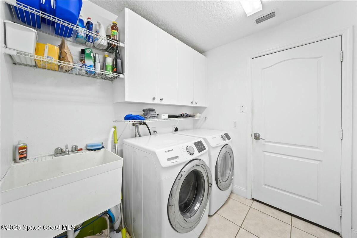 1366 Blazen Ridge Court Melbourne, FL 32934 - Photo 20 of 23 a utility room with dryer and washer