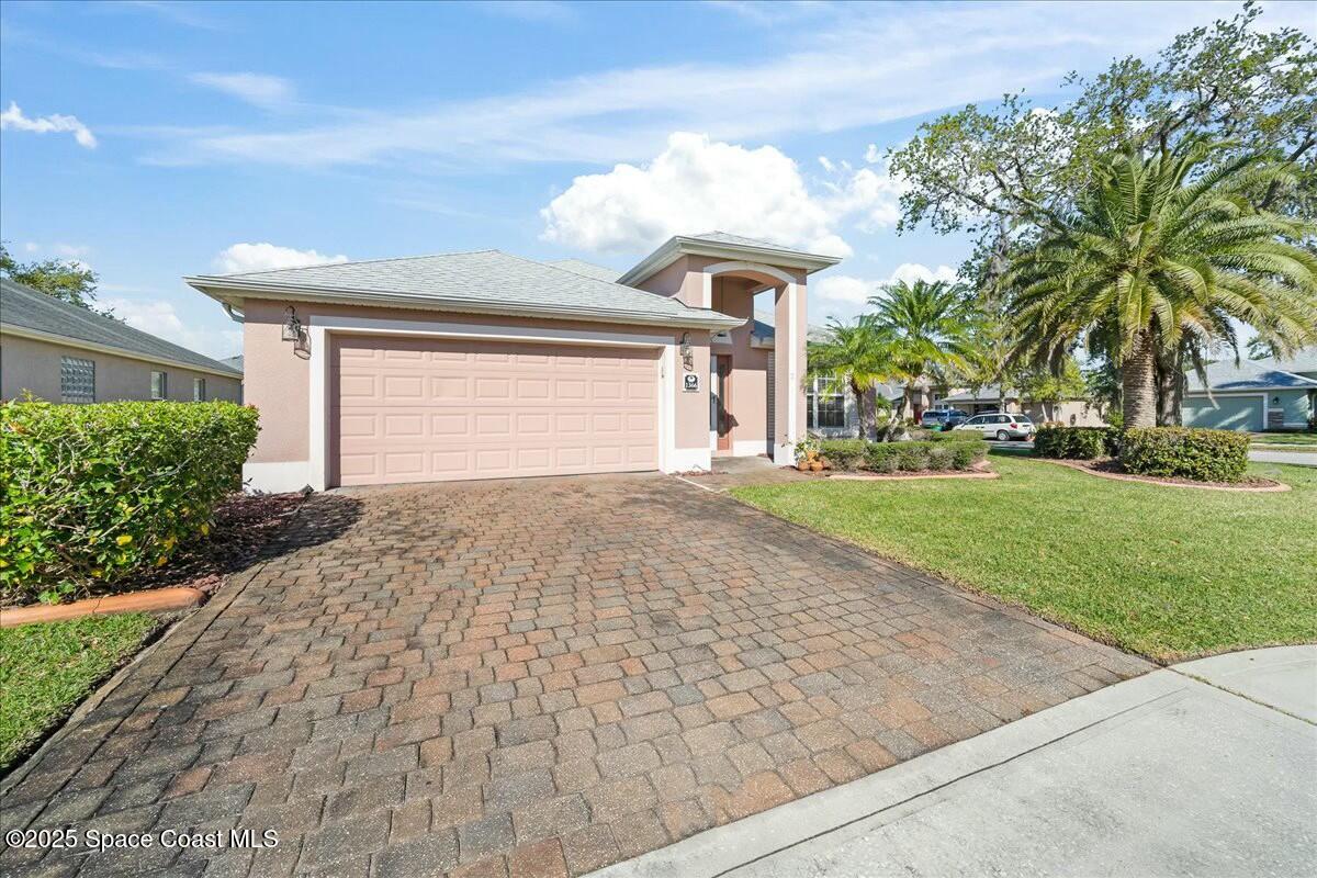 1366 Blazen Ridge Court Melbourne, FL 32934 - Photo 2 of 23 a front view of a house with a yard and garage