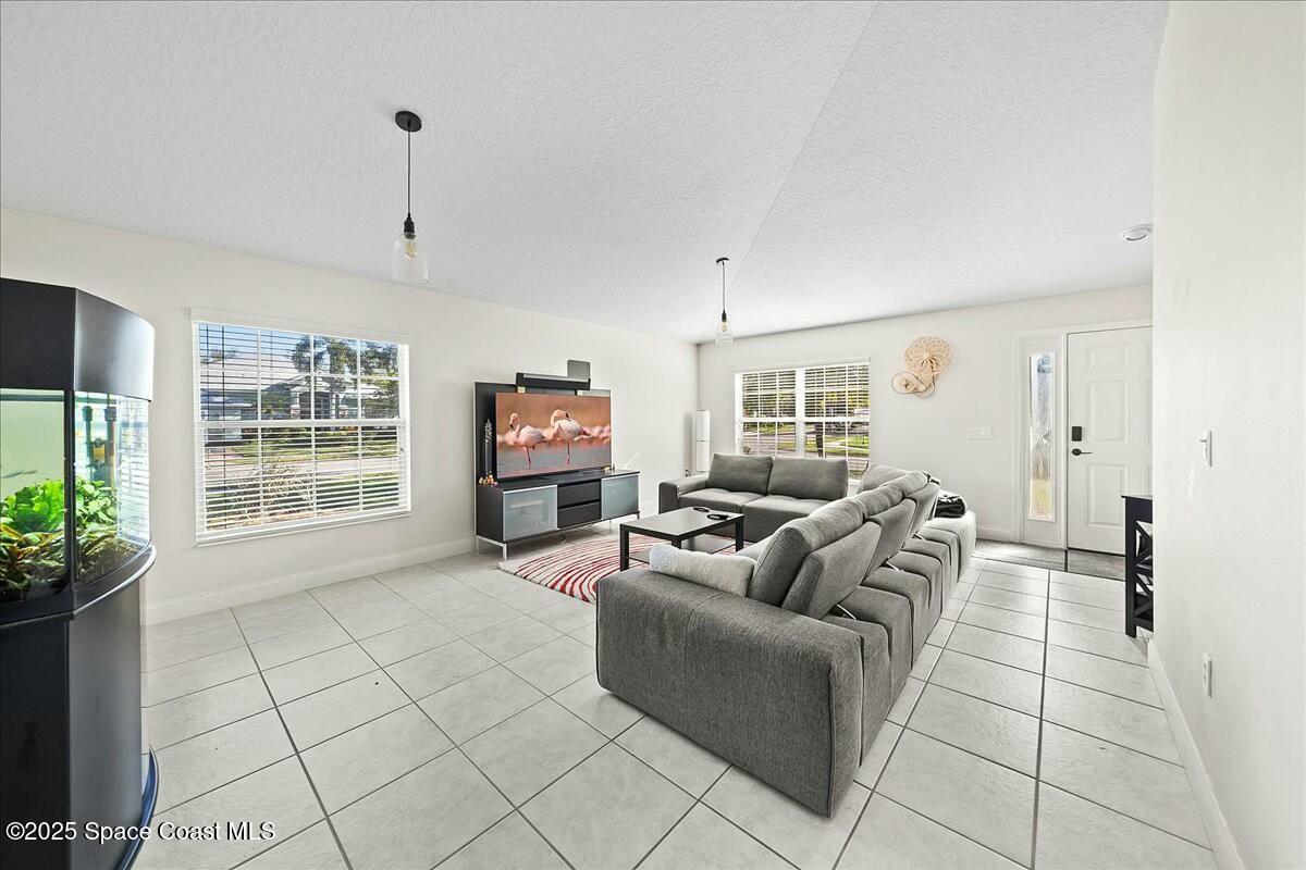 1366 Blazen Ridge Court Melbourne, FL 32934 - Photo 4 of 23 a living room with furniture and a flat screen tv