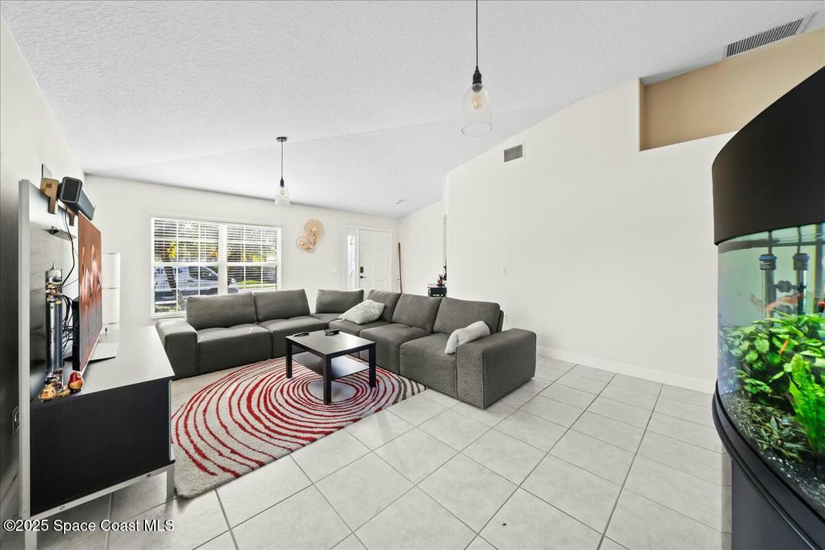 1366 Blazen Ridge Court Melbourne, FL 32934 - Photo 5 of 23 a living room with furniture and a flat screen tv