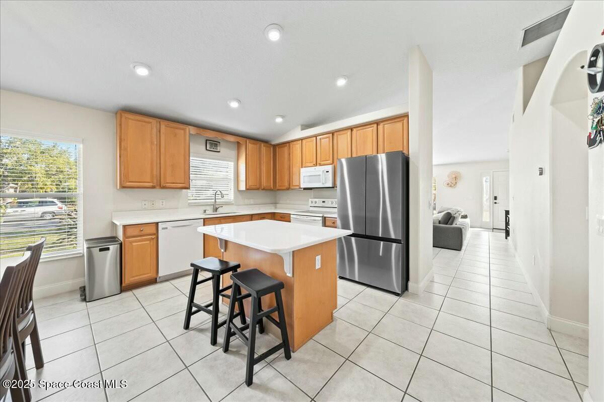1366 Blazen Ridge Court Melbourne, FL 32934 - Photo 6 of 23 a kitchen with stainless steel appliances granite countertop a refrigerator and a stove top oven