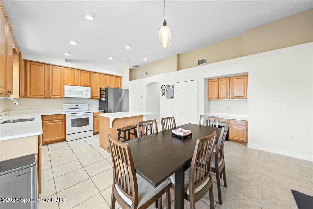 1366 Blazen Ridge Court Melbourne, FL 32934 - Photo 8 of 23 a view of a dining room with furniture