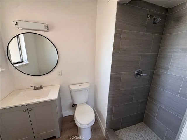 a bathroom with a toilet sink and a mirror