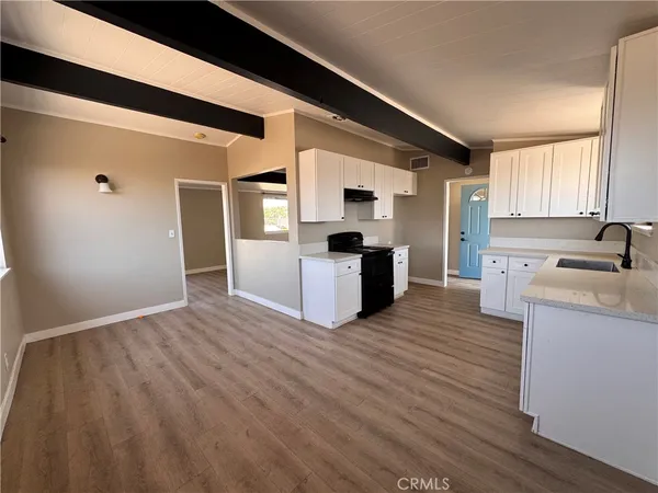 a view of kitchen with stainless steel appliances granite countertop a refrigerator and a sink