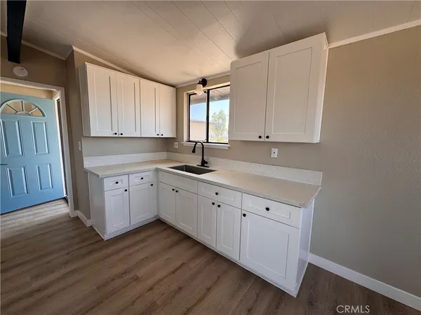 a kitchen with sink cabinets and window