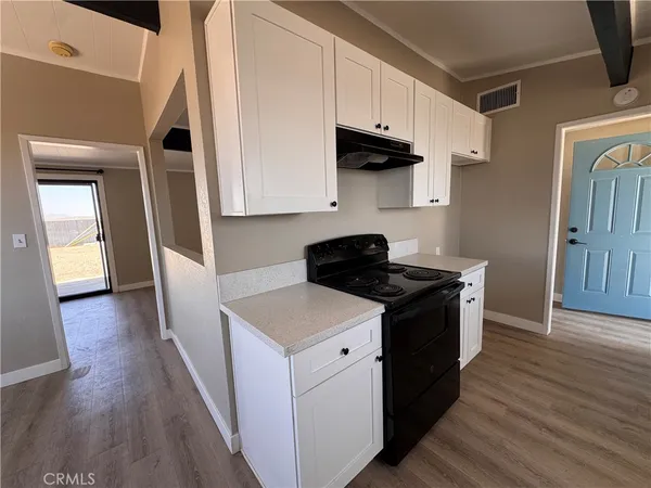 a kitchen with stainless steel appliances granite countertop a stove and a refrigerator