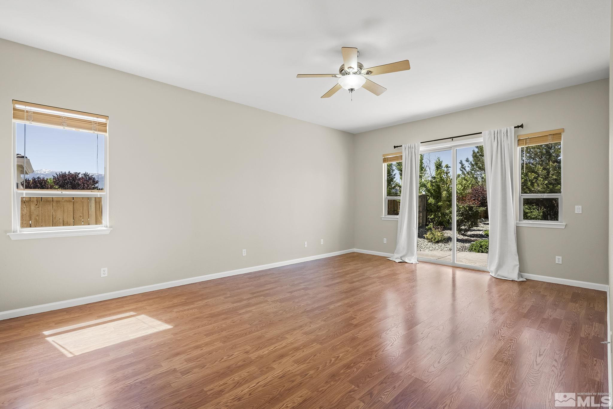 2685 Alder Bridge Court Reno, NV 89521 - Photo 13 of 38 a view of an empty room with wooden floor and a window