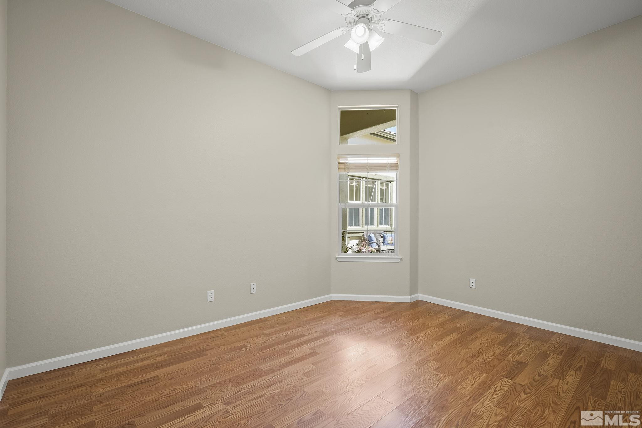 2685 Alder Bridge Court Reno, NV 89521 - Photo 16 of 38 an empty room with wooden floor and windows