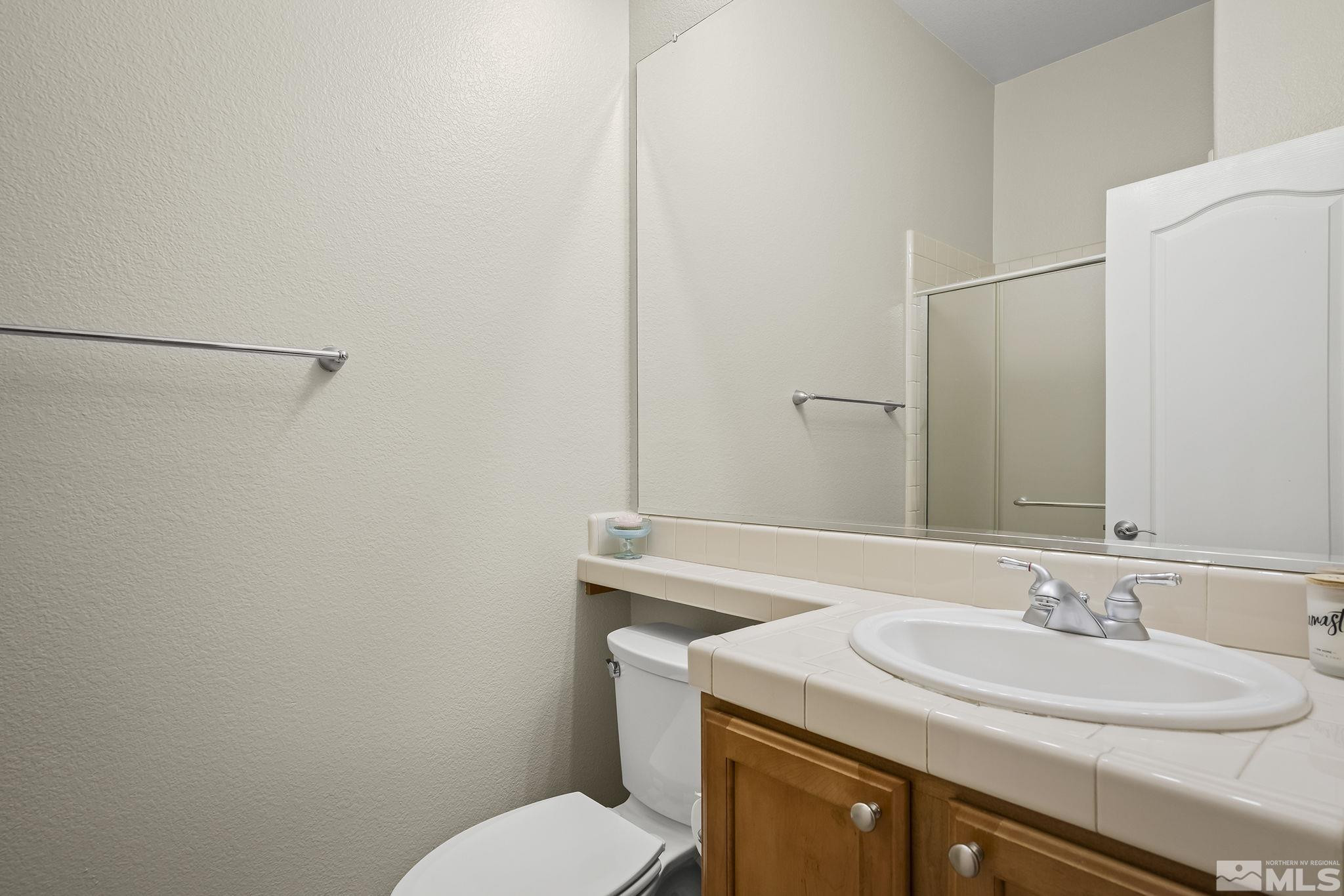 2685 Alder Bridge Court Reno, NV 89521 - Photo 17 of 38 a bathroom with a sink toilet and a mirror